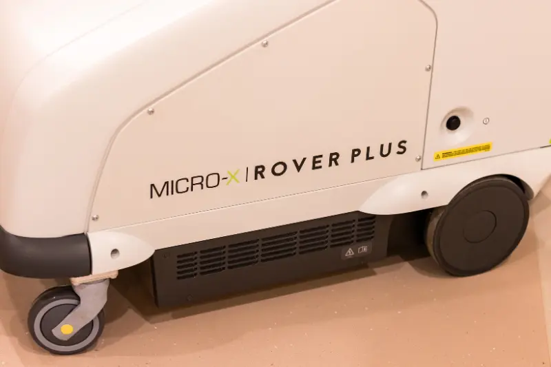 Close-up view of the MICRO-X Rover Plus mobile X-ray machine showing its wheels and side branding